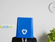 man with recylcing bin on his head